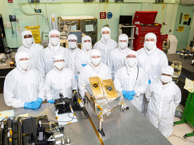 Members of the Ocean Color Instrument Main Optics Sub Bench (MOSB) integration team pose with the hardware prior to its integration onto the Main Optics Bench (MOB). Credit: Stover, Desiree