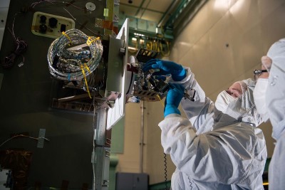 Installing the solar array drive assembly on the PACE spacecraft bus. Credit: Lambert, Barbara