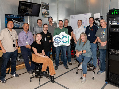 The Ocean Color Instrument Electro-Magnetic Interference (EMI) & Electrical Ground Support Equipment (EGSE) Team pose in the control room at at Goddard Space Flight Center. Credit: Mellos, Katherine