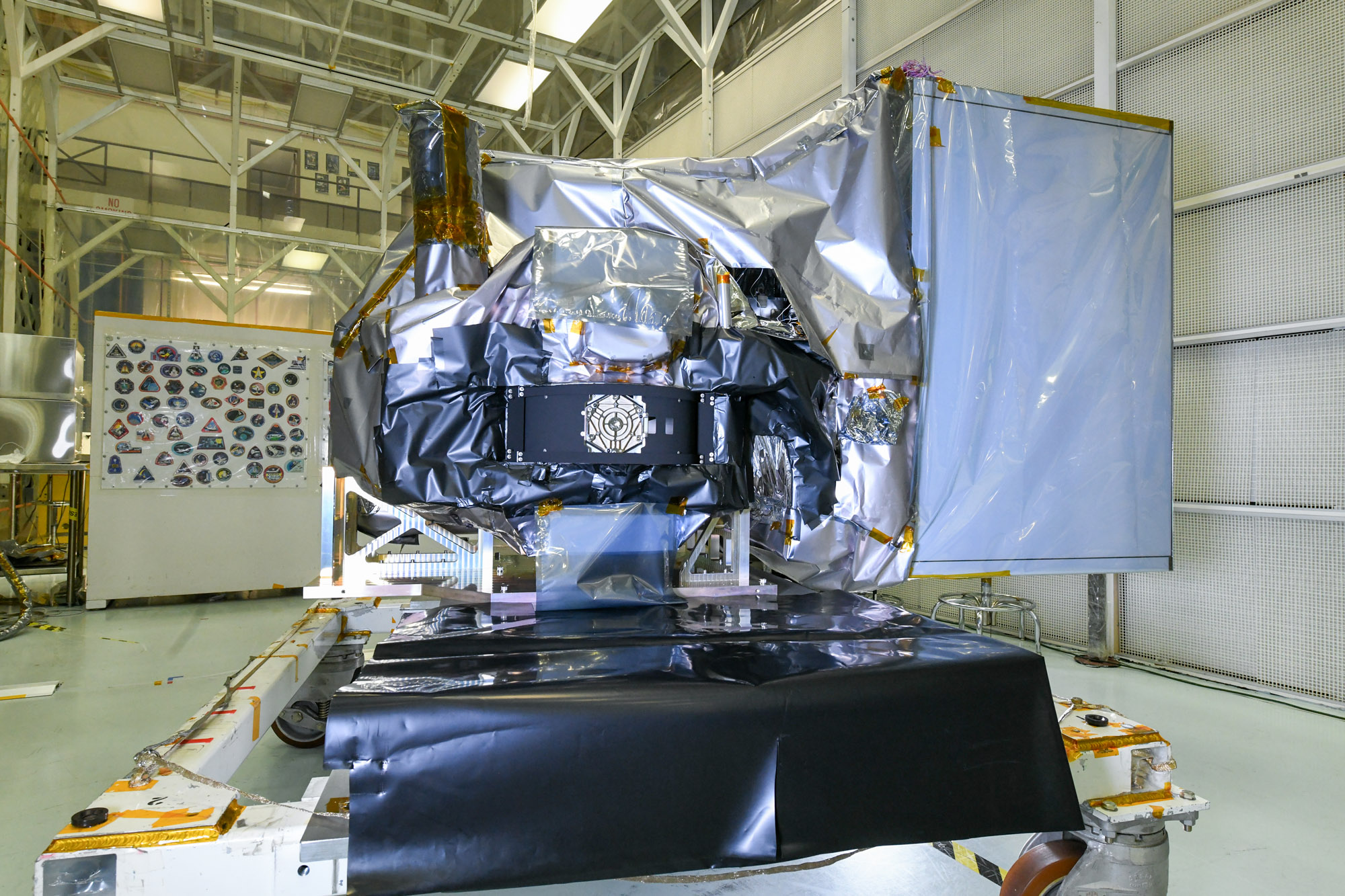 The Ocean Color Instrument (OCI) is prepared for environmental testing with installed thermal blankets and flight Earth Shade in a cleanroom at Goddard Space Flight Center.