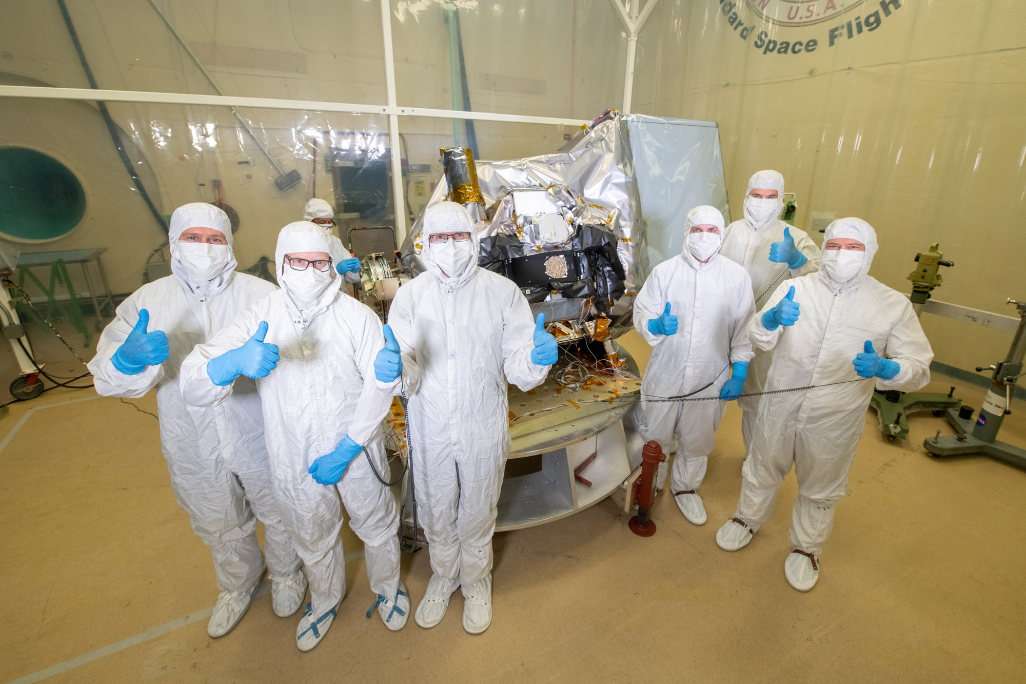 Ocean Color Instrument managers (Brian Clemons, Eric Gorman, Ulrik Gliese, Leland Chemerys, Joe Knuble, Robby Estep) pose with the instrument in the acoustic chamber.