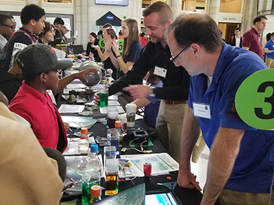 Visitors at the NASA Earth Day Celebration at Union Station (Washington D.C.) check out water with different optical properties while learning about PACE ocean color measurements. Credit: NASA GSFC