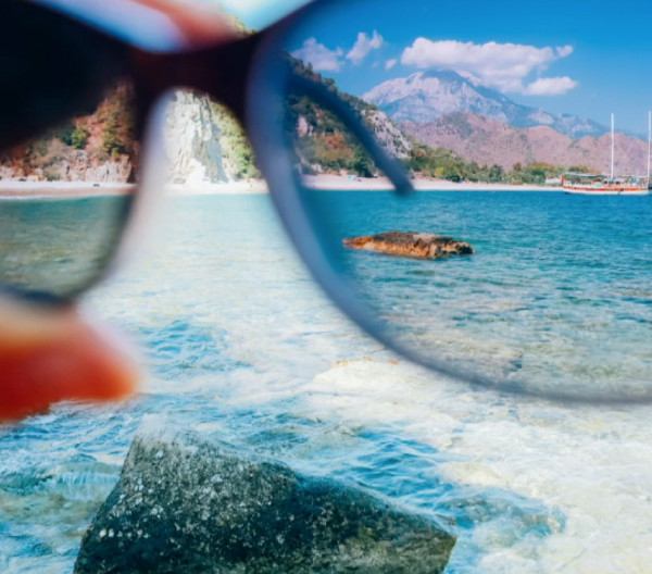 Looking through sunglasses at the ocean