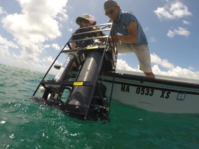 A package of instruments is deployed during the CORAL field campaign. This cage contains instruments that measure how light is absorbed and scattered in water. Credit: Daniel Schar (HIMB)