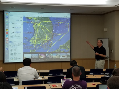 Scientists discuss the combined ship-based and airborne tracks for the field campaign
