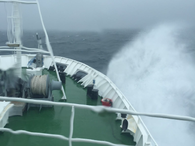 Waves break over the bow of the RV Onnuri in rough seas