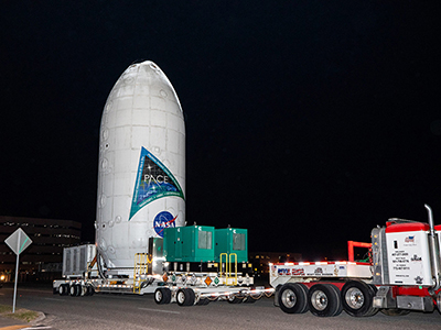NASA’s PACE spacecraft encapsulated inside SpaceX’s Falcon 9 payload fairings is transported from the Astrotech Space Operations Facility near the agency’s Kennedy Space Center in Florida. Photo credit: NASA/Ben Smegelsky Credit: NASA