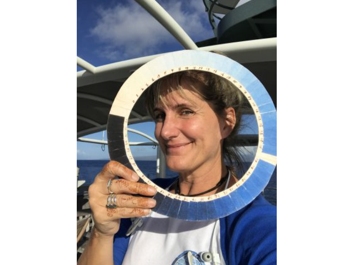 Kirsten Carlson poses with a replica of a cyanometer