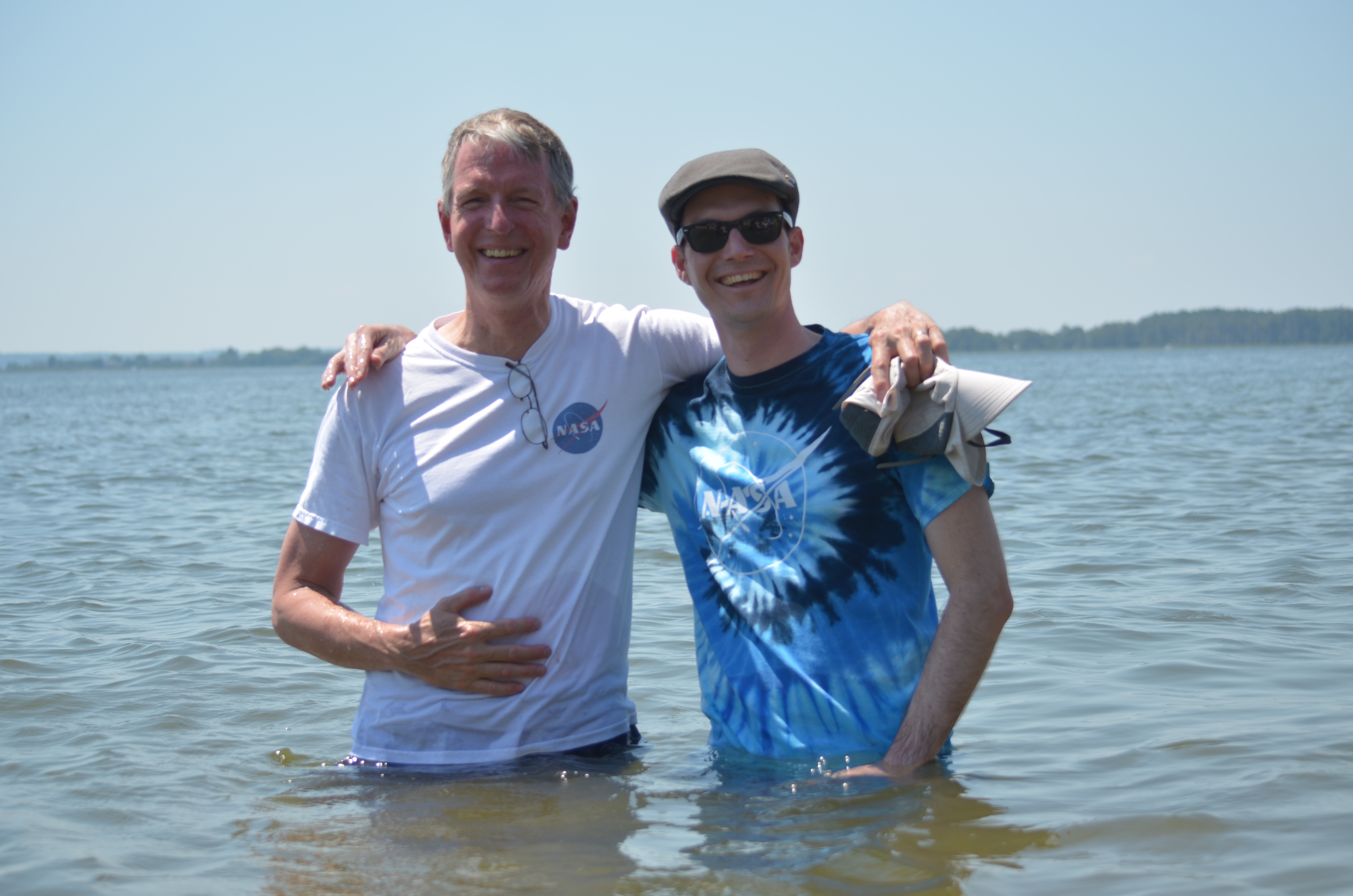 Ocean color scientists Norman Kuring (left) and Lachlan McKinna (right) wade waist-deep into the Chesapeake Bay to measure the "Sneaker Depth" of the water - the depth where a pair of white sneakers can no longer be seen.