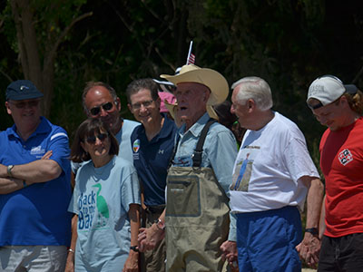 Bernie Fowler leads a group of citizens and scientists into the Chesapeake Bay for an annual water quality measurement known as the "Sneaker Depth." Credit: NASA GSFC